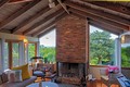 Living room w/ wood burning fireplace and view