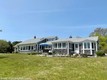 The exterior of the main house with the back deck and bluestone patio.