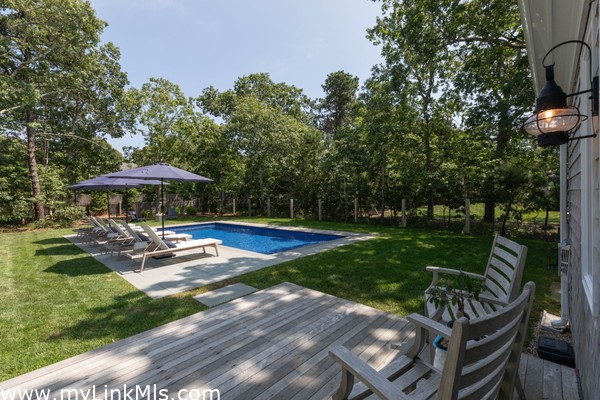 Back deck overlooking the pool with access to the outdoor shower