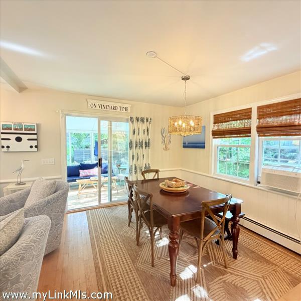 Dining open floor plan with sliders to enclosed sun porch