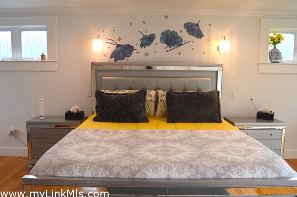 primary bedroom with private bath, balcony and walk-in-closet