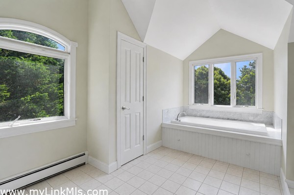 Primary en-suite bath with soaking tub and separate shower