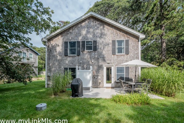 Back of home with outdoor shower