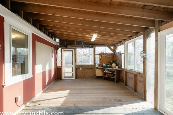 Three Season Porch with a Door to the Outdoor Shower and Sliding Doors with views to the Meadow.