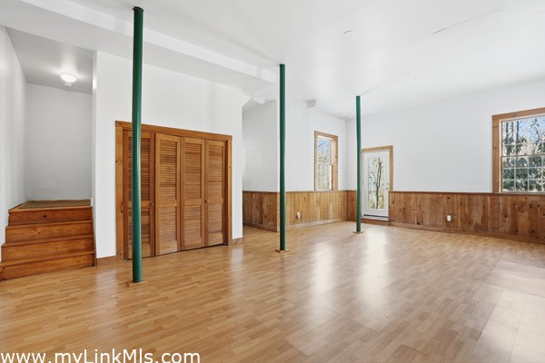 Bright basement with closet and door to the exterior 18 foot ceiling