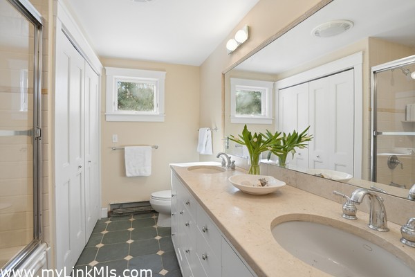 First floor full bath with double sinks and tub/shower, washer/dryer.