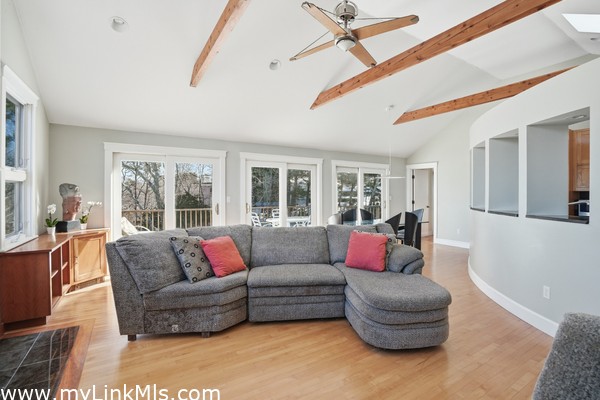Bright open concept living space to outdoor deck three sliders