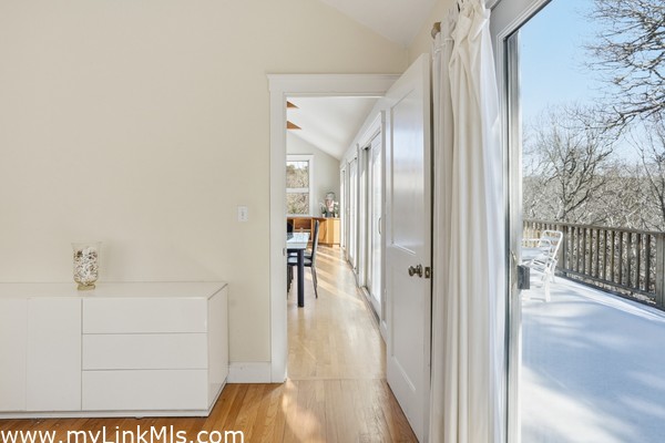 Primary bedroom to living area with deck access.