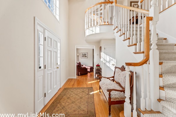 Elegant carved staircase leads to the second floor from the grand foyer.