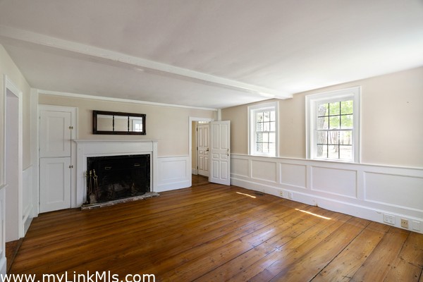 A third fireplace in the living room at the front of the house
