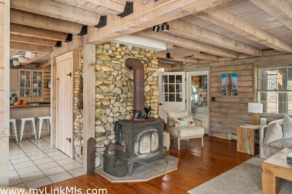 Beach stone chimney and wood stove for cozy gatherings with family and friends