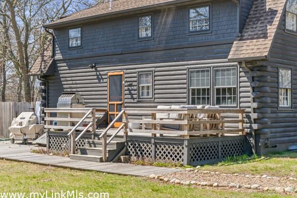 Main house back deck and patio area with grill and outdoor shower