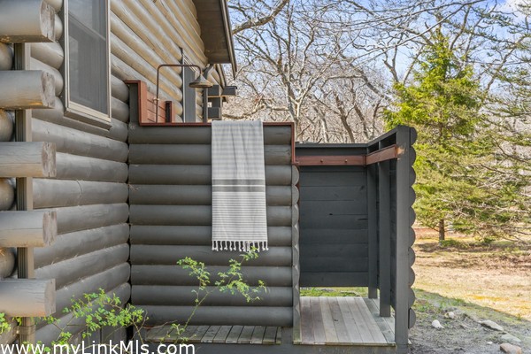 Beautiful copper hardware in custom outdoor shower with changing area