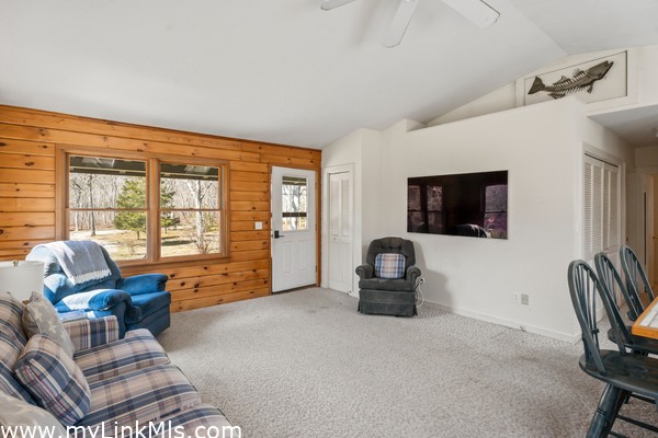 Open floor plan with vaulted ceilings, skylights and front door from the large porch and sliding doors to the enormous back deck with bench seating, grill station and outdoor shower/dressing area