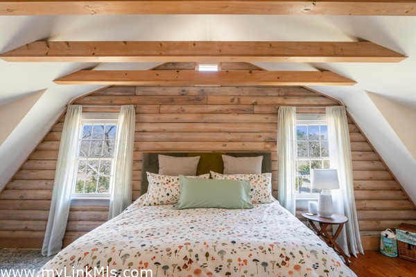 2nd flr - Primary Bedroom with walk-in closet wood floors and vaulted ceilings