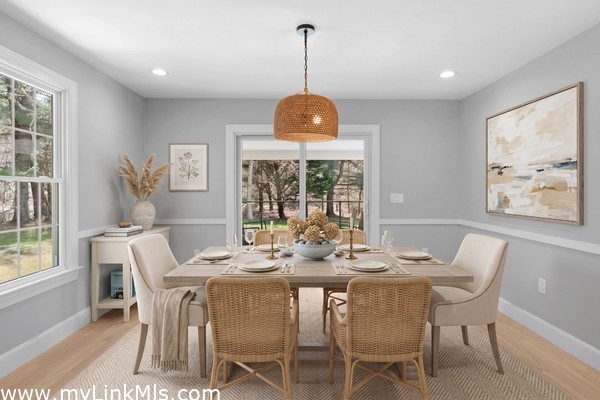 Dining room conveniently located between the living room and kitchen, with sliders out to the porch. Virtually staged.