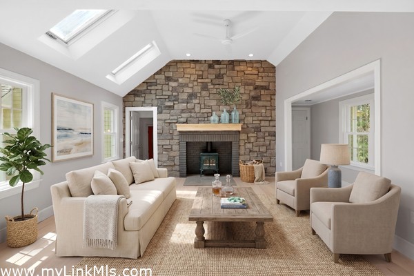 Inviting family room with cathedral ceiling, sky lights, propane stove and access to garage on the left and variable use office/game room to the right. Virtually staged.