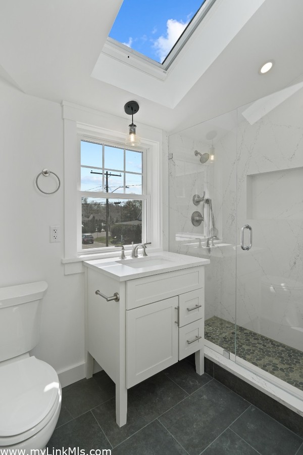 Luxurious full bathroom highlighted by Quartz and stone and glass finishings on second level in primary unit.