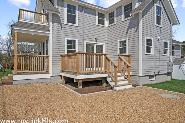 Primary residence - deck, parking, covered front porch and second floor balcony.