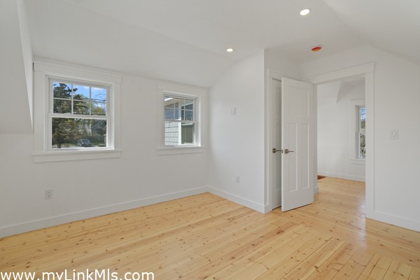 Main bedroom in primary unit with hardwood oak flooring and climate control.