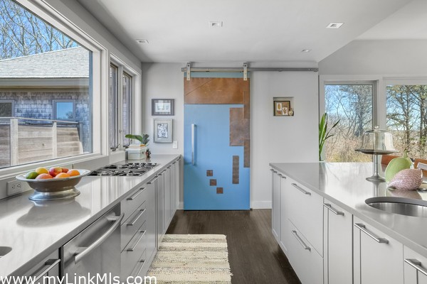 Decorative barn door conceals a generous pantry space.