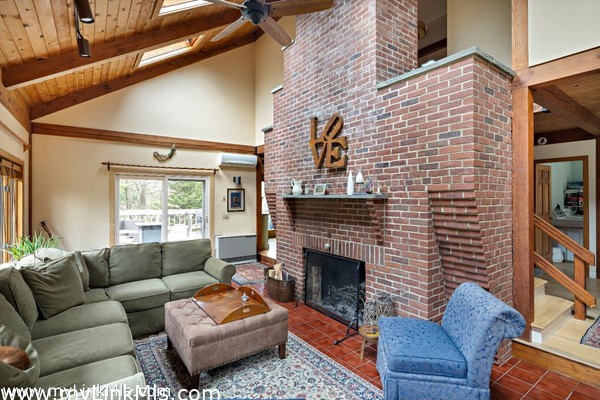 Floor-ceiling brick wood-burning fireplace