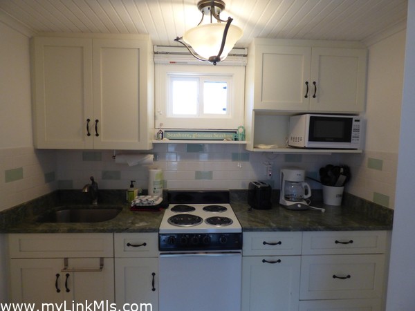 Kitchen with full size refrigerator, 4 burner electric oven, microwave