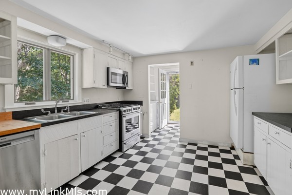 Kitchen view into laundry area and side door