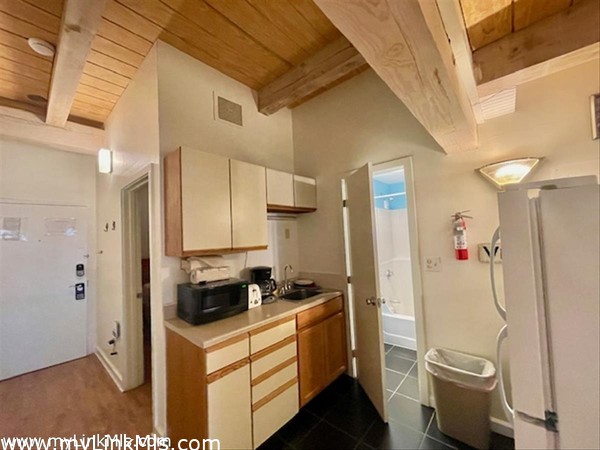 kitchen has full oven/range + with post and beam ceiling opens to full bath