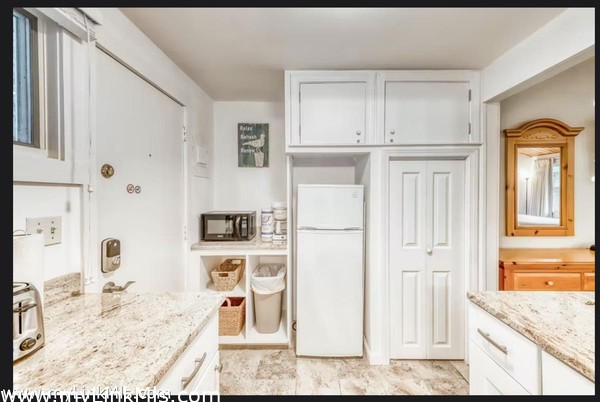 Kitchenette with Refrigerator and Storage Area