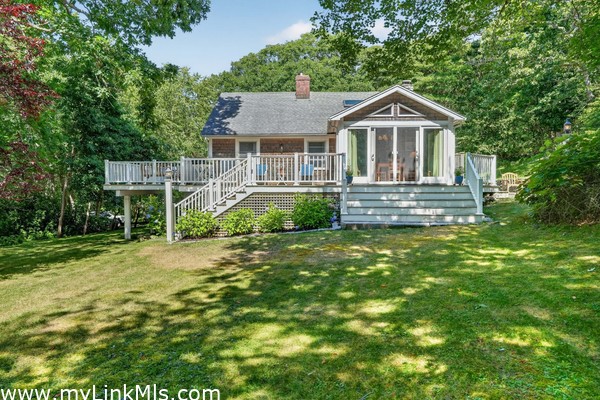 The wide staircase leading to the Main House living space and the wraparound porch with terraces to the right.