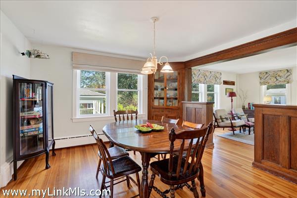 Built-in China cabinets and a beamed entrance to the dining room adds architectural interest.