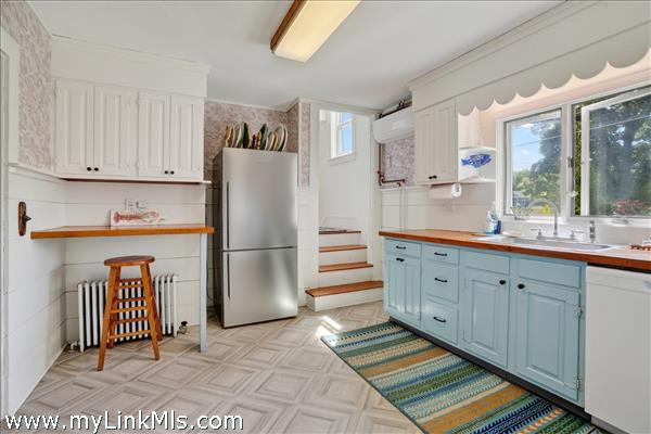 The staircase to the second floor provides a shortcut to the living room and front door.