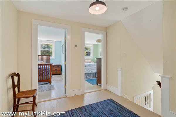 A spacious upper hallway opens to the four corner bedrooms.