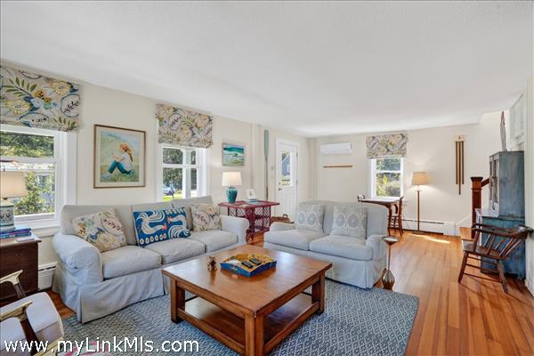 The warm patina of newly refinished Carolina pine floors enhances the living and dining rooms.