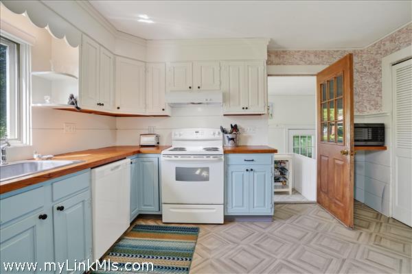The kitchen is accessed through the heated rear entry