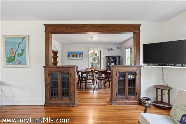 The architectural detail of the framed entrance to the dining room creates a gracious separation of the dining and living area.