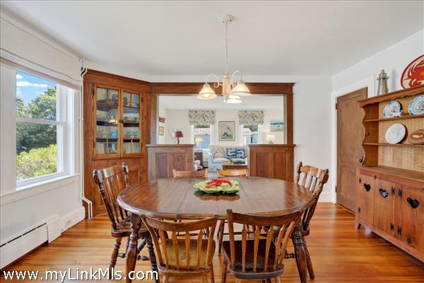 The charming dining room features a corner built-in China cupboard.